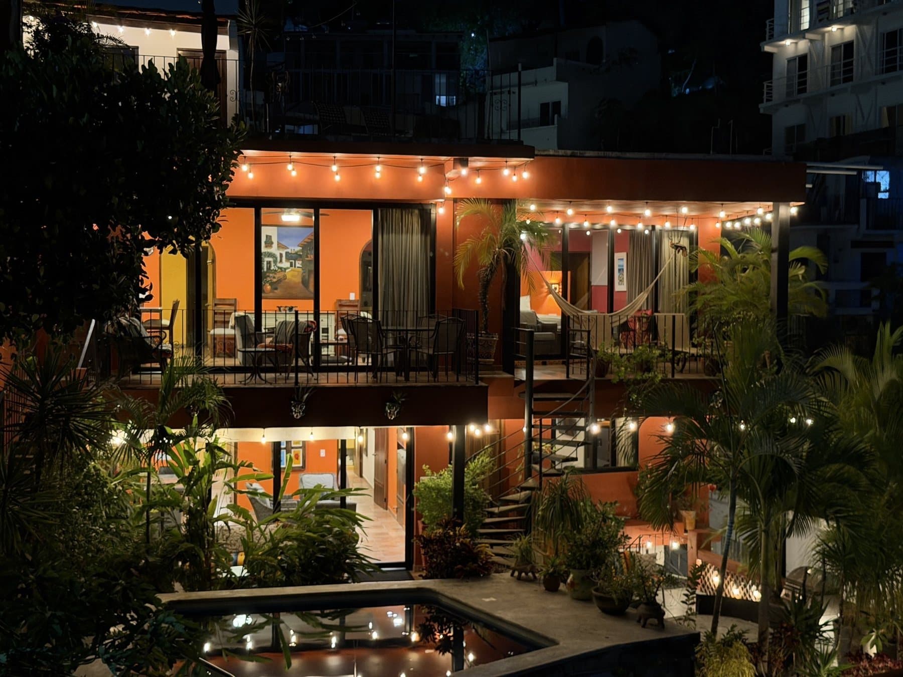 Villa Amistad at dusk, lit from end to end