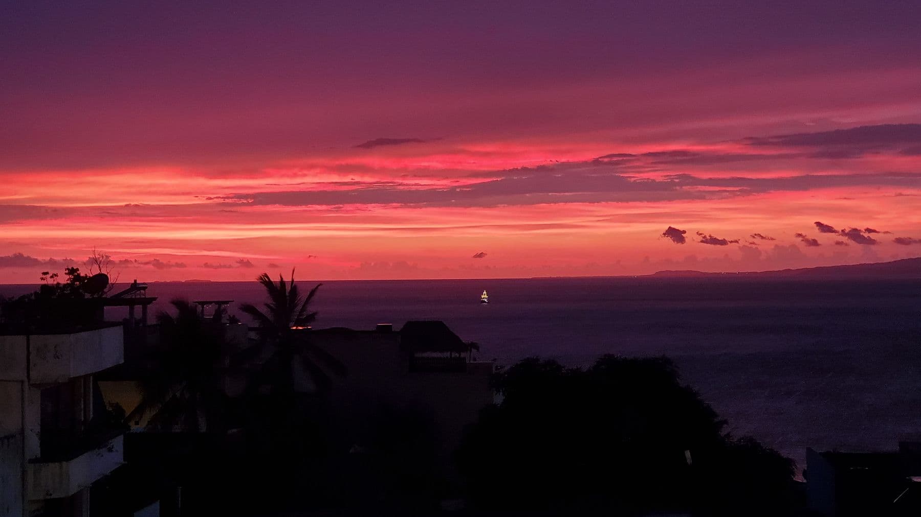 A rose and violet sunset over Banderas Bay, seen from Villa Amistad's terrace