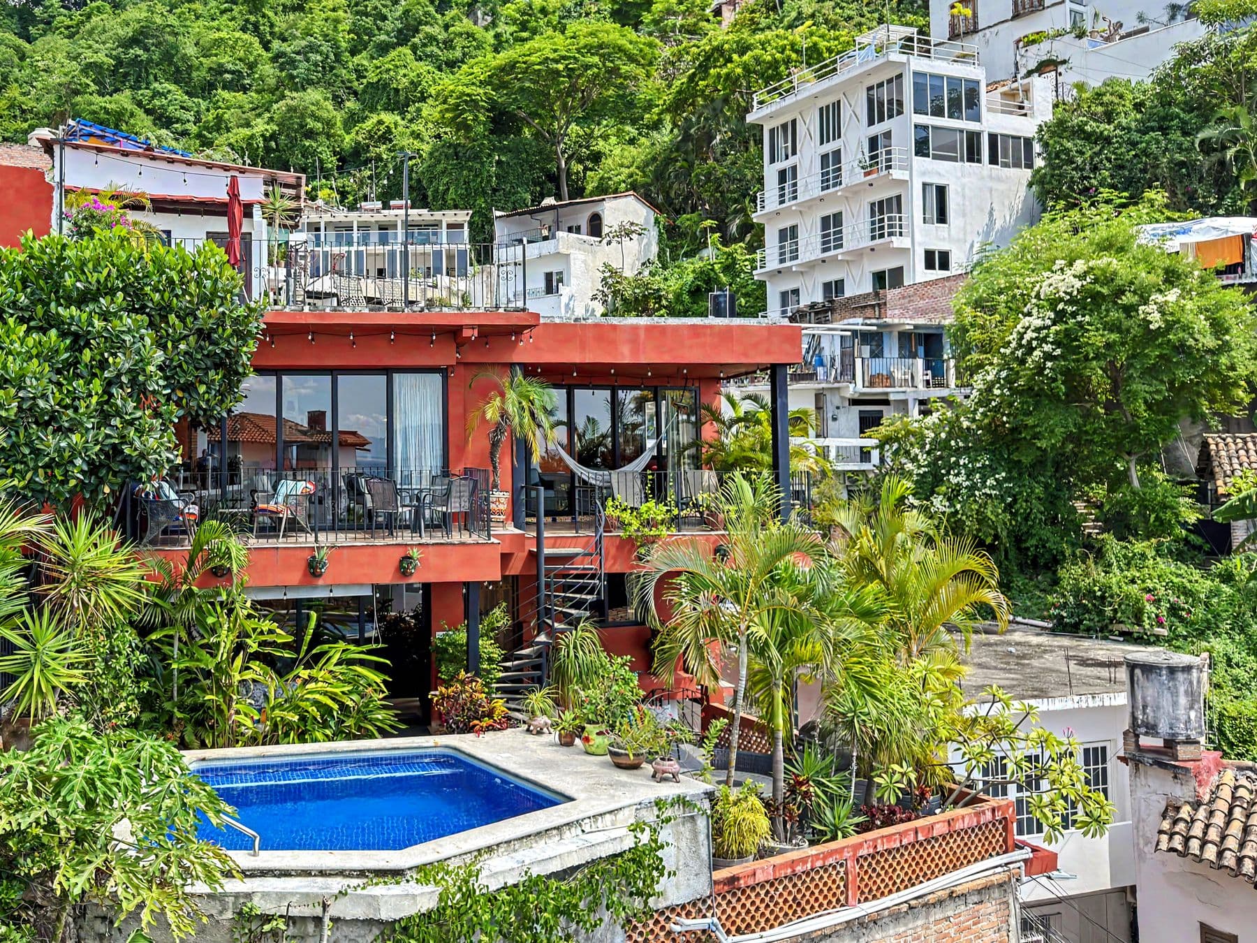 Villa Amistad by day, among its neighbours on the El Cerro hillside