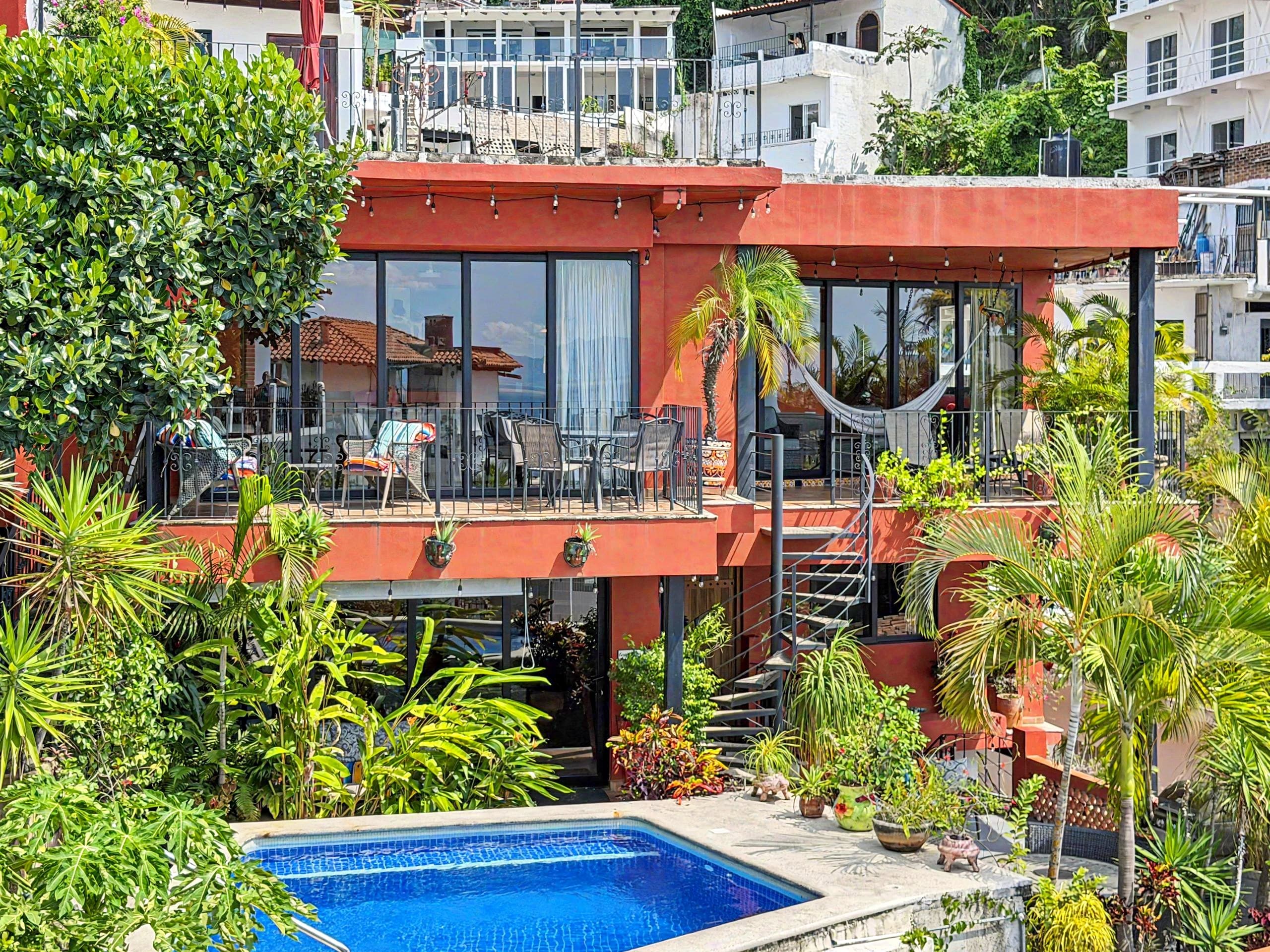 Villa Amistad by day: both terraces, the hammock, the spiral stair and the pool in front